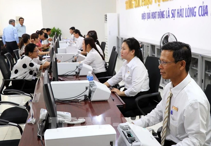 Seamless public services for citizens and businesses must be ensured during the transition to a streamlined two-tier local administration model. Photo: VNA