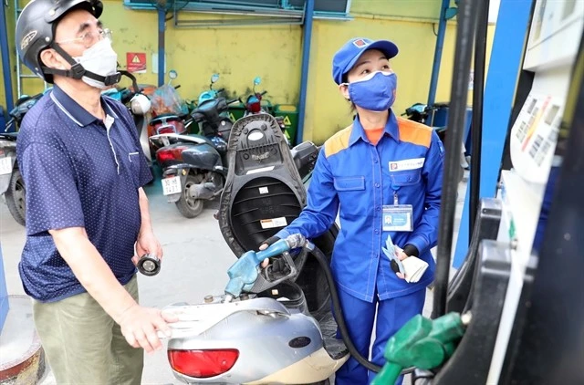 A customer buys petrol at a station in Hanoi. Photo: VNA